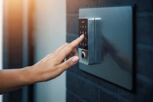 Person typing on electronic lock keypad to enter home.